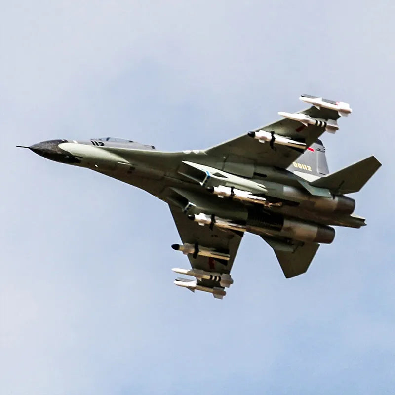 RC EDF jet fighter flying at high speed against a blue sky